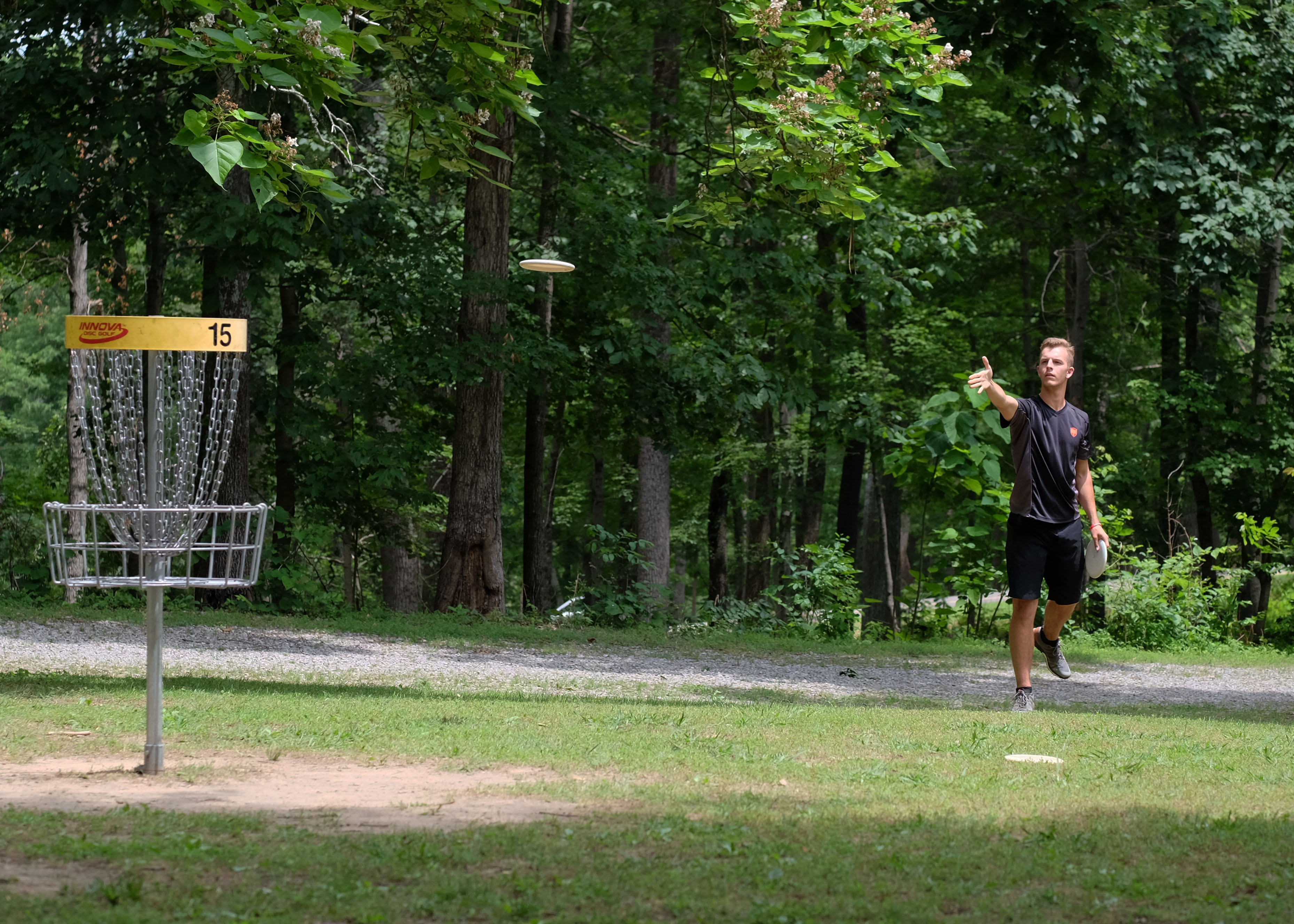 An image showing man playing disc golf frisbee