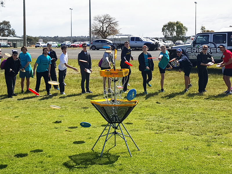 An image showing group of people playing disc golf frisbee