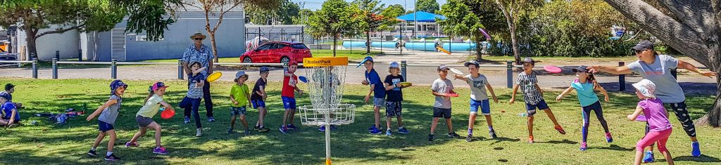 An image of group of kids playing disc golf