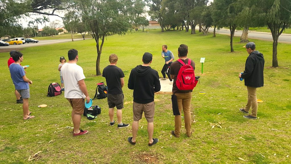 an image of group of men playing disc golf