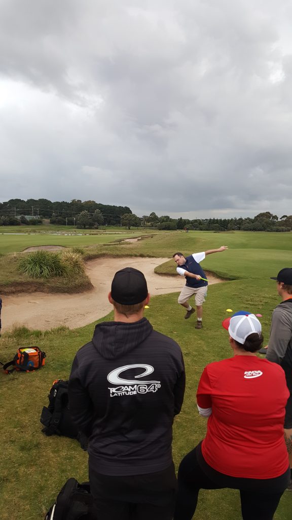 an image showing man playing disc golf