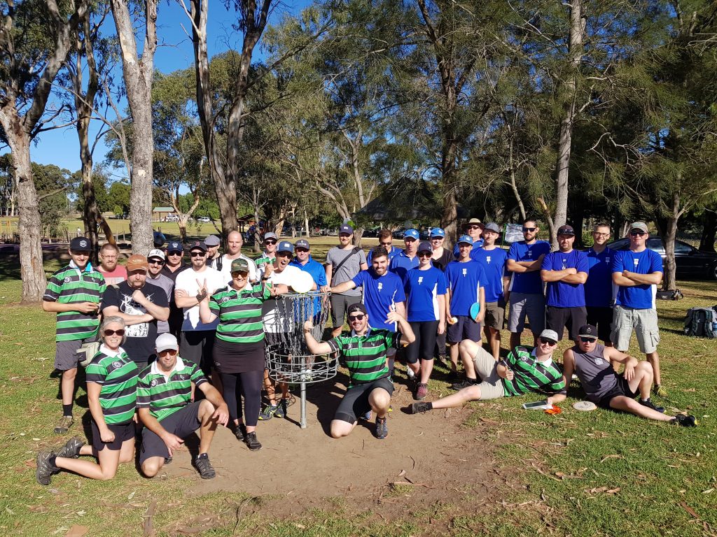 An image of group of people in a disc golf park 