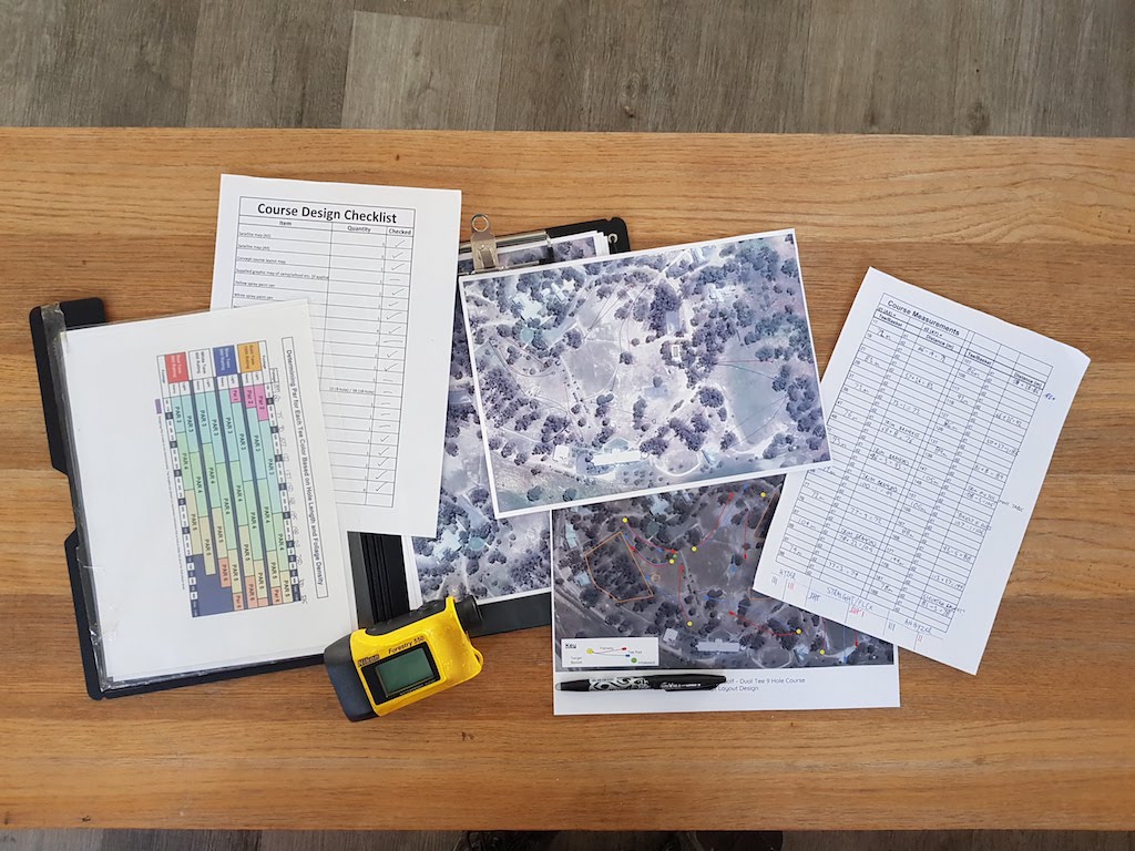 an image of papers and designs of a disc golf course