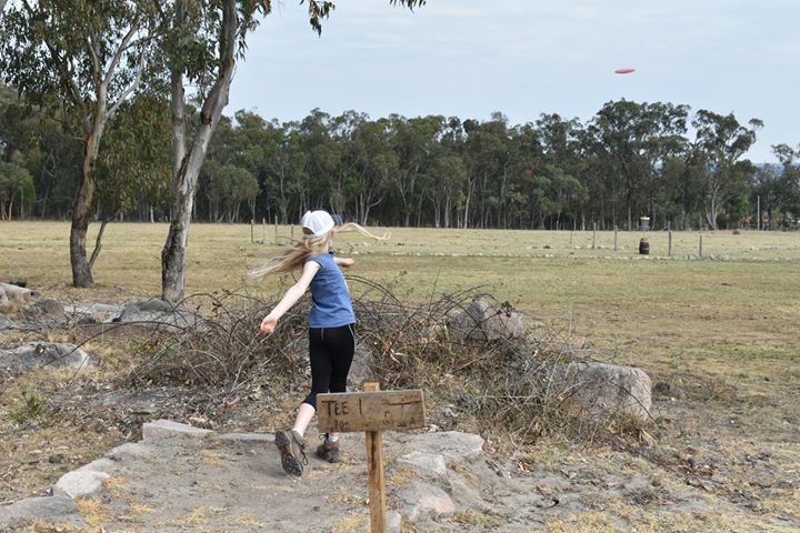 an image of a girl playing disc golf in Granite Mountain Disc golf course