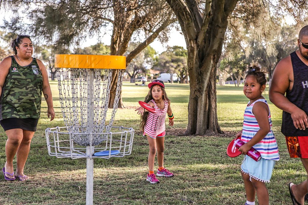 an image of a family playing disc golf