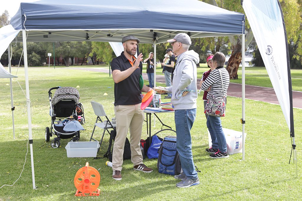 an image of people discussing in disc golf park