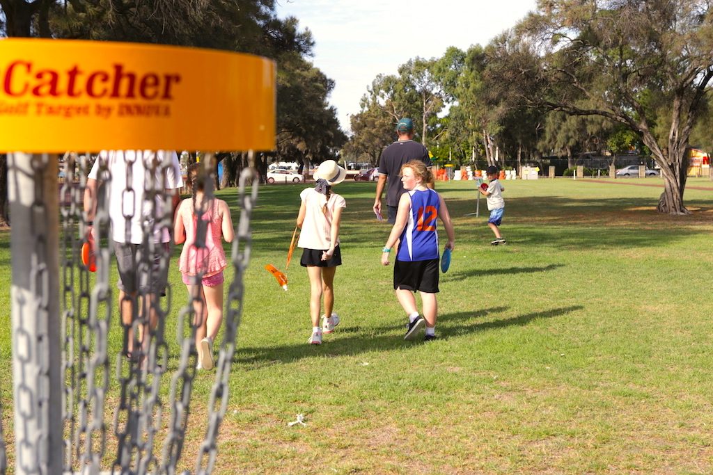 an image of boys and girls playing disc golf