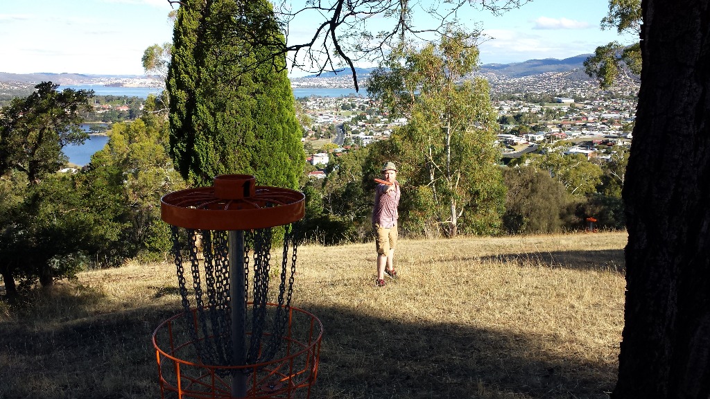 an image of a man playing disc golf in a disc golf course