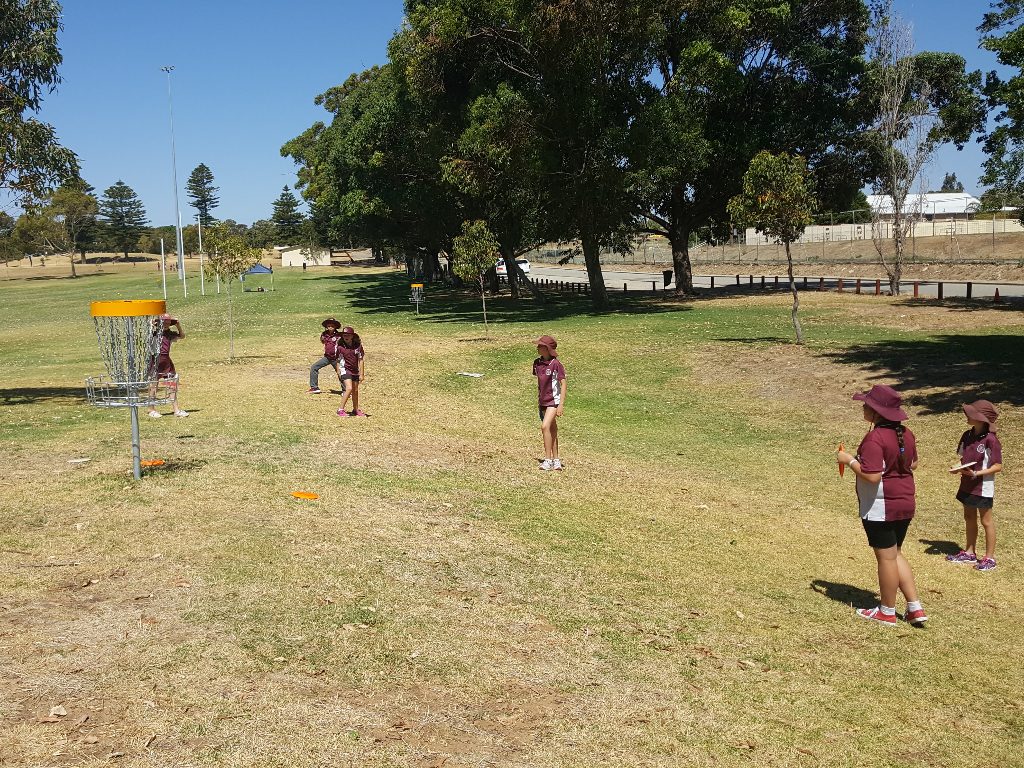 an image of kids playing disc golf