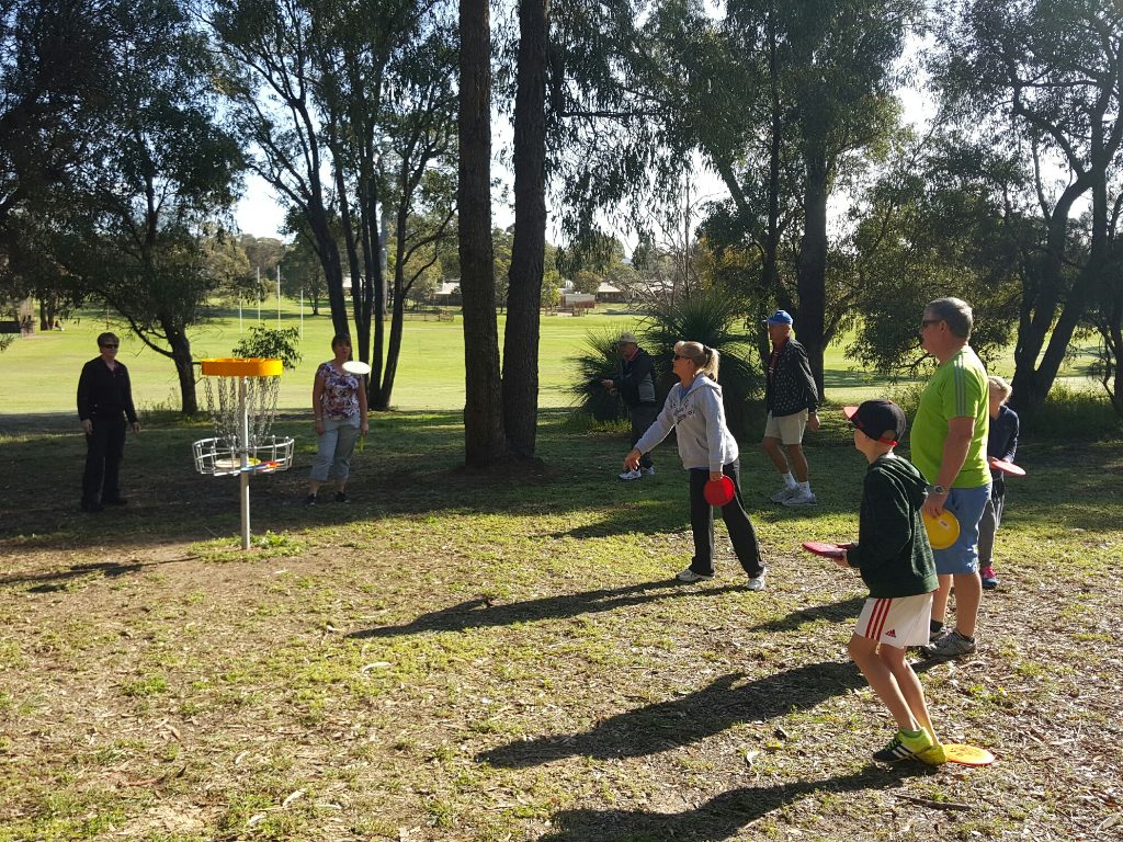 an image of family playing disc golf