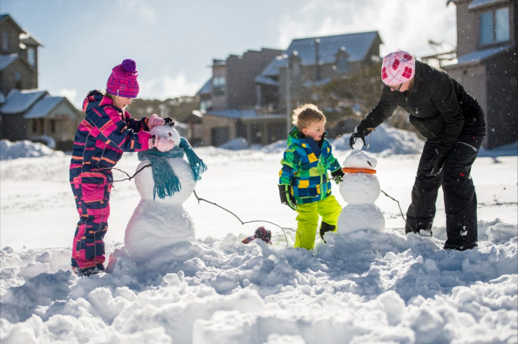 an image of kids playing and making snowman