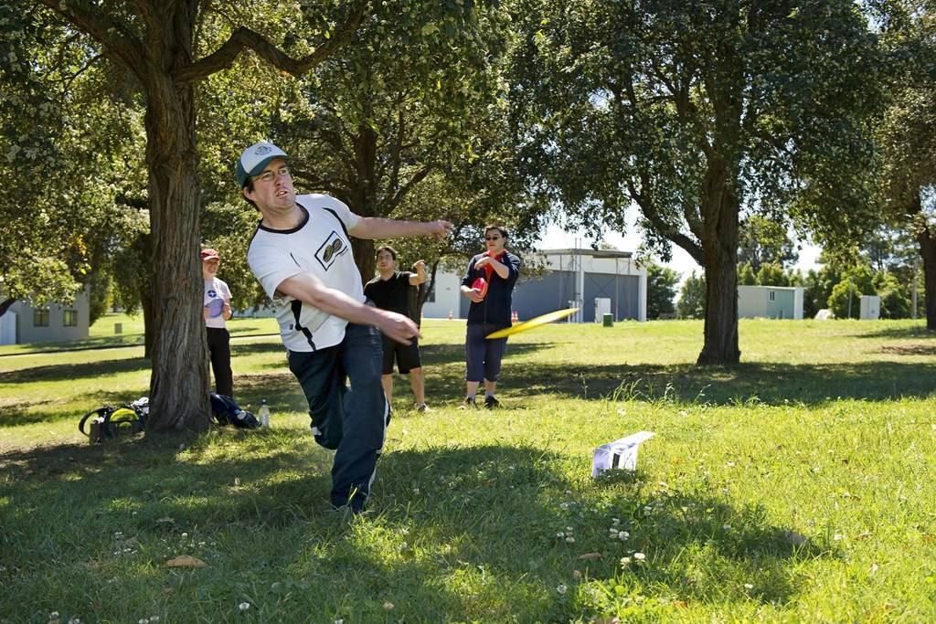 an image of a man playing disc golf