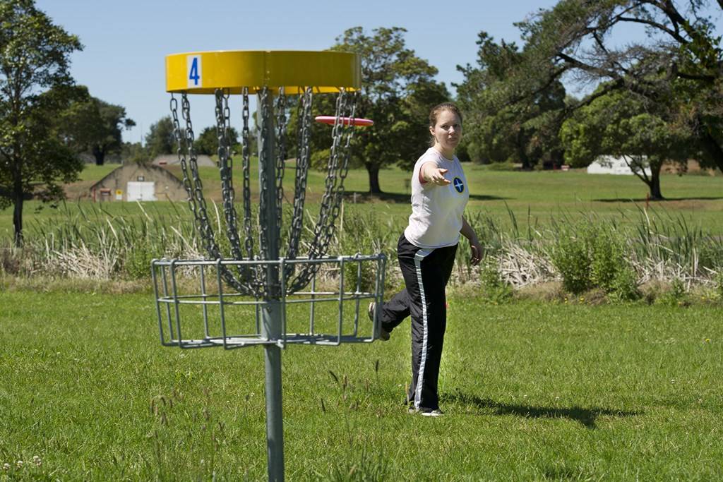 an image of a girl playing disc golf