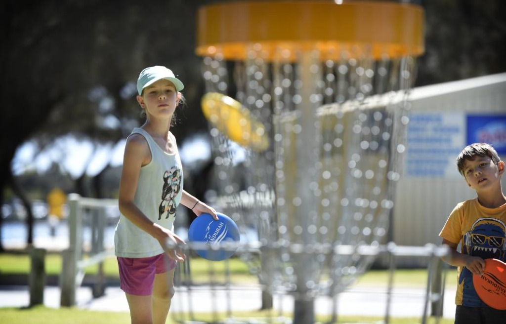 an image of a girl playing disc golf